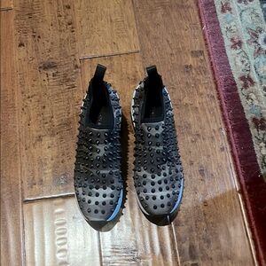 Black Studded Slip-On Sneakers
Brand Gianni Bini